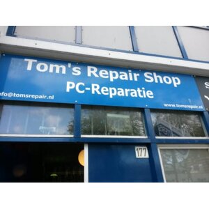 Tom&#039;s Repair Shop logo