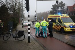 Fietser rijdt door rood en schrikt van auto uit uitrit